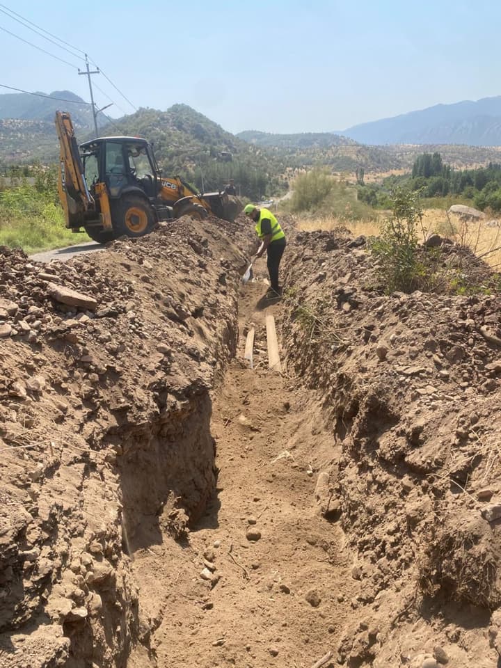 Excavator digging a trench