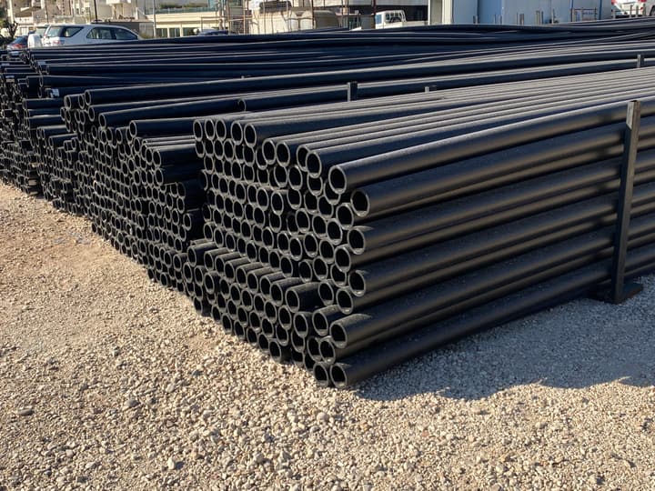 HDPE pipes stacked in a storage yard