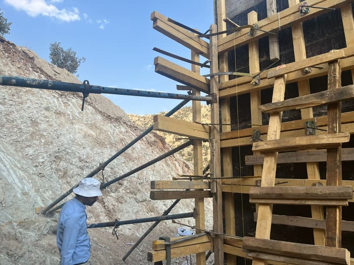 Workers installing pipe in a trench