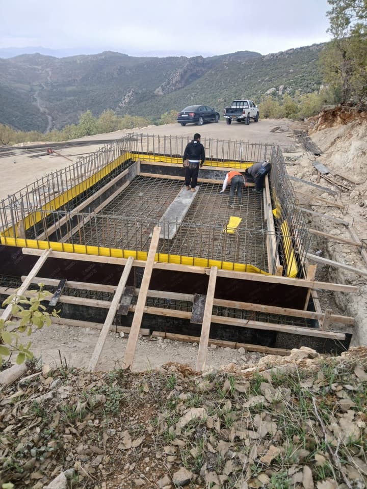 Workers installing pipe in a trench